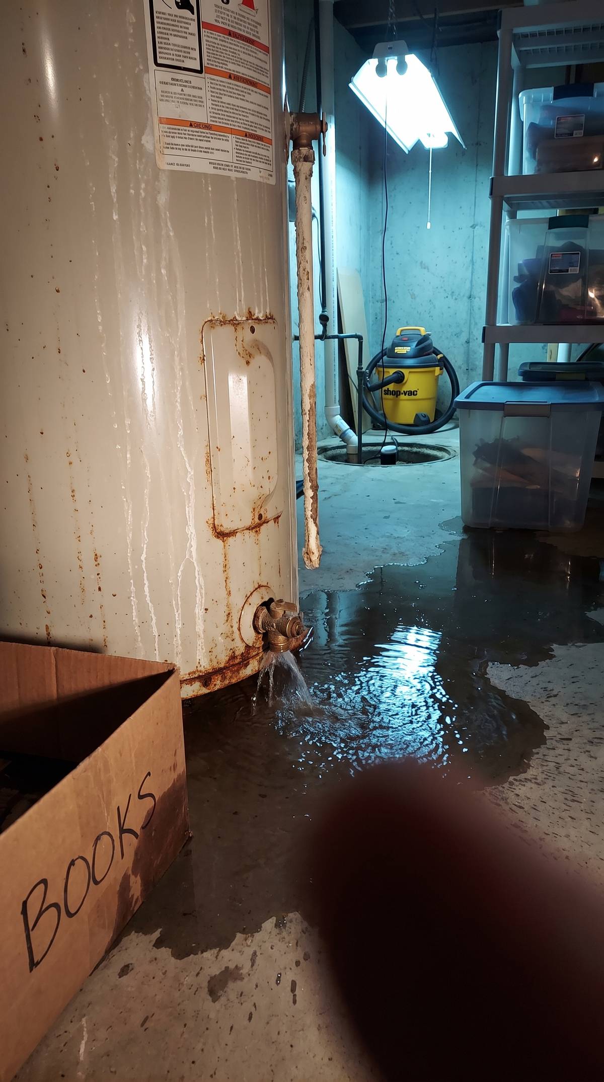 Water heater leaking and flooding a Rhode Island basement - emergency repair needed