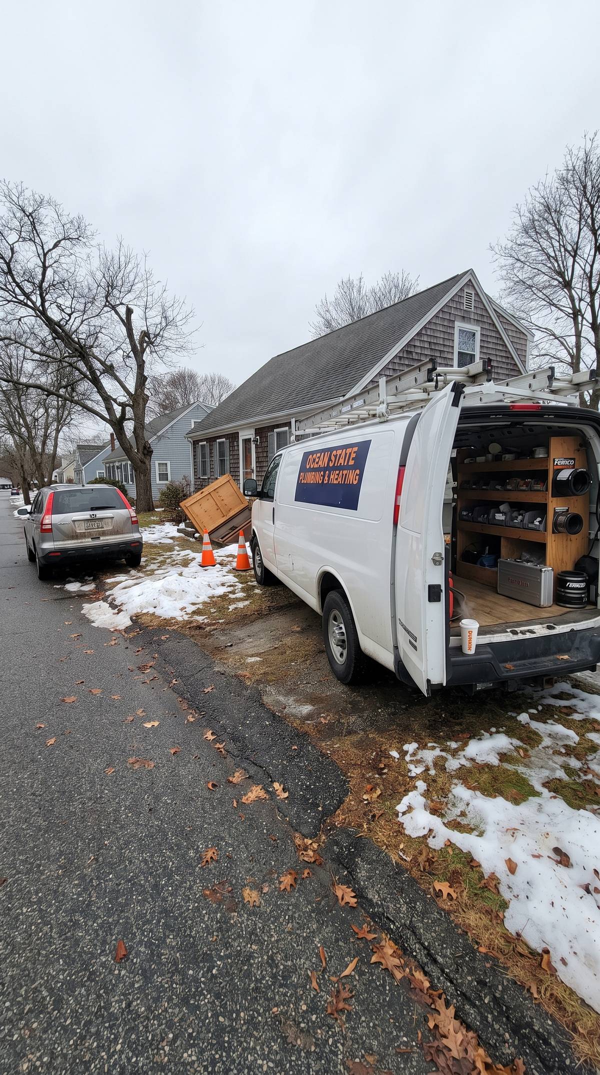 Water heater service van parked at a Rhode Island home for a repair call